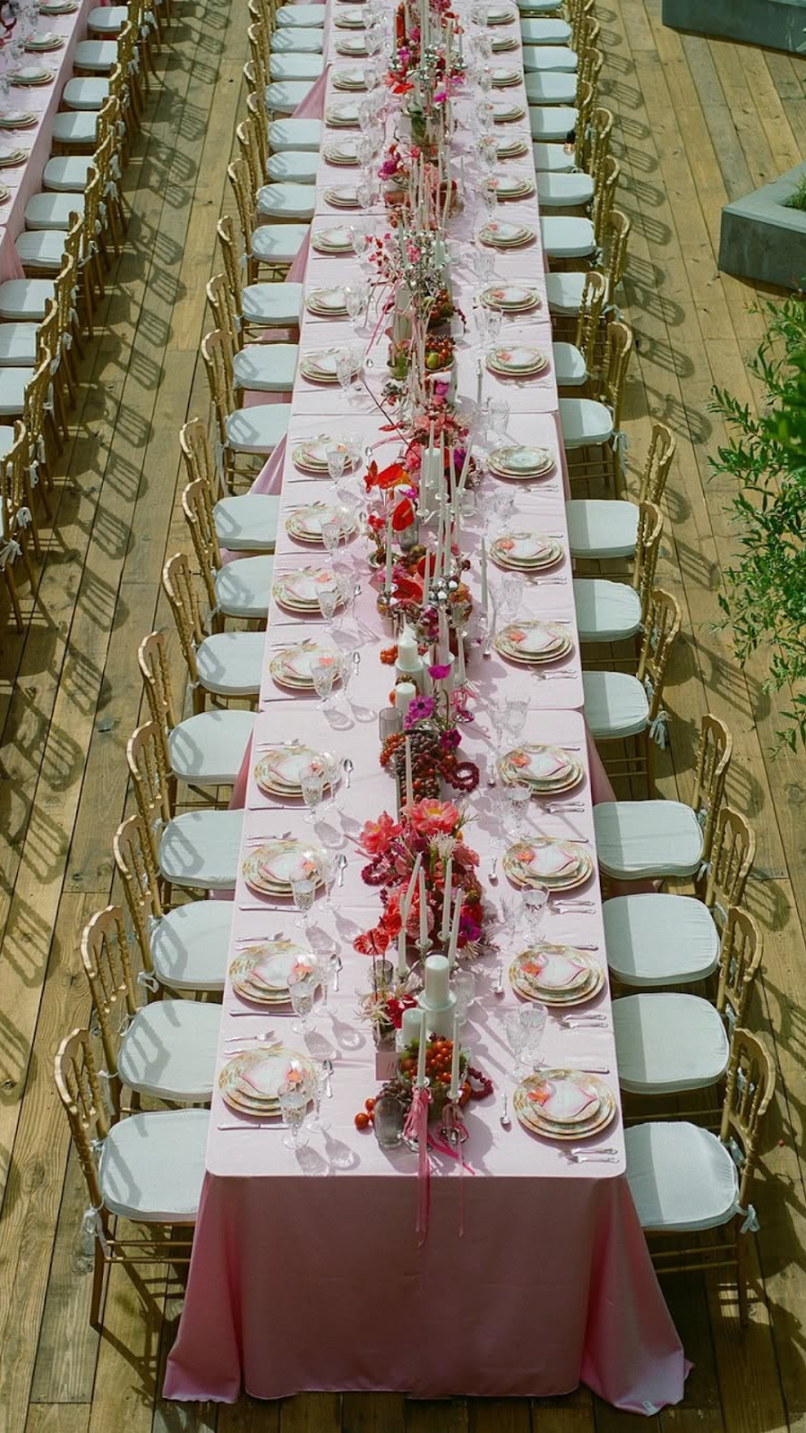 Rectangular tables draped with pale pink linens and paired with Chiavari chairs.
